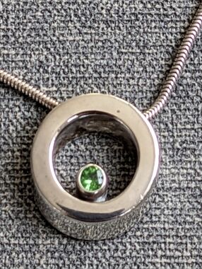 Movado 3D circle necklace with genuine peridot stone Vintage